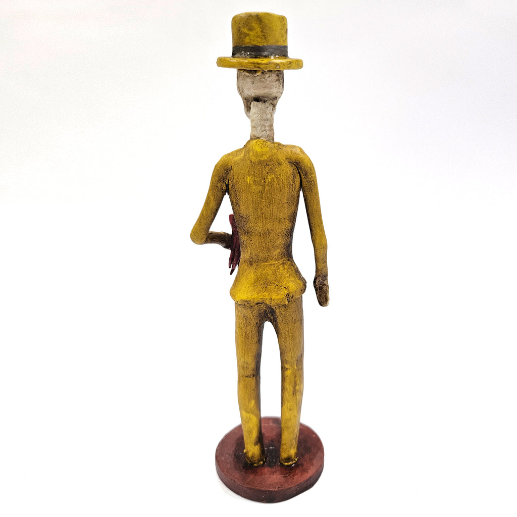 Elegant Catrin dressed w/yellow suit flowers in hand