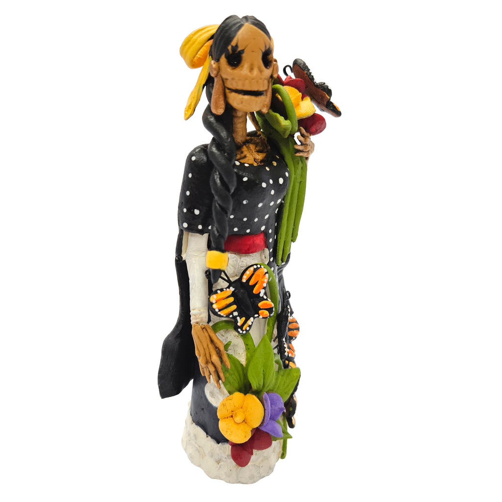 Beautiful Catrina dressed in black with basket of flowers and butterflies